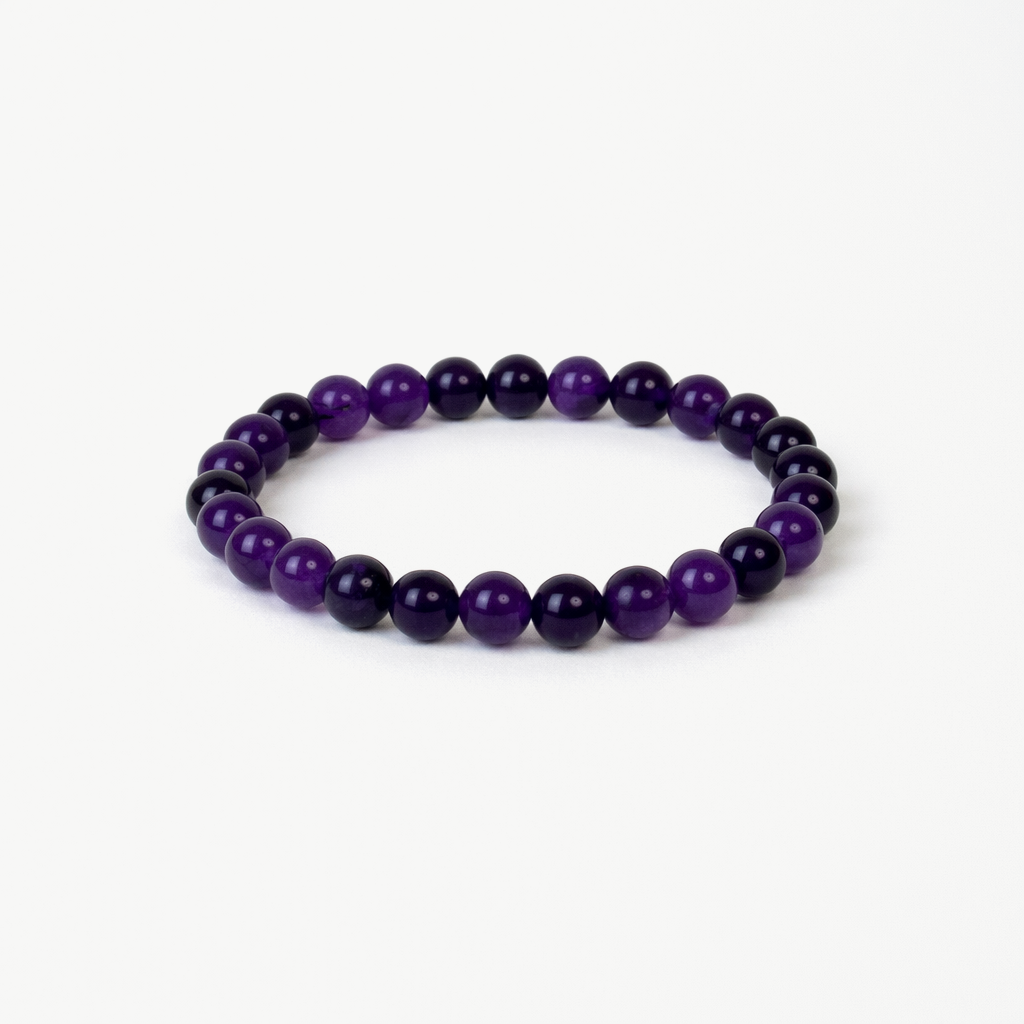 amethyst beaded bracelet with deep purple polished round stones on a stretch cord, on a white background