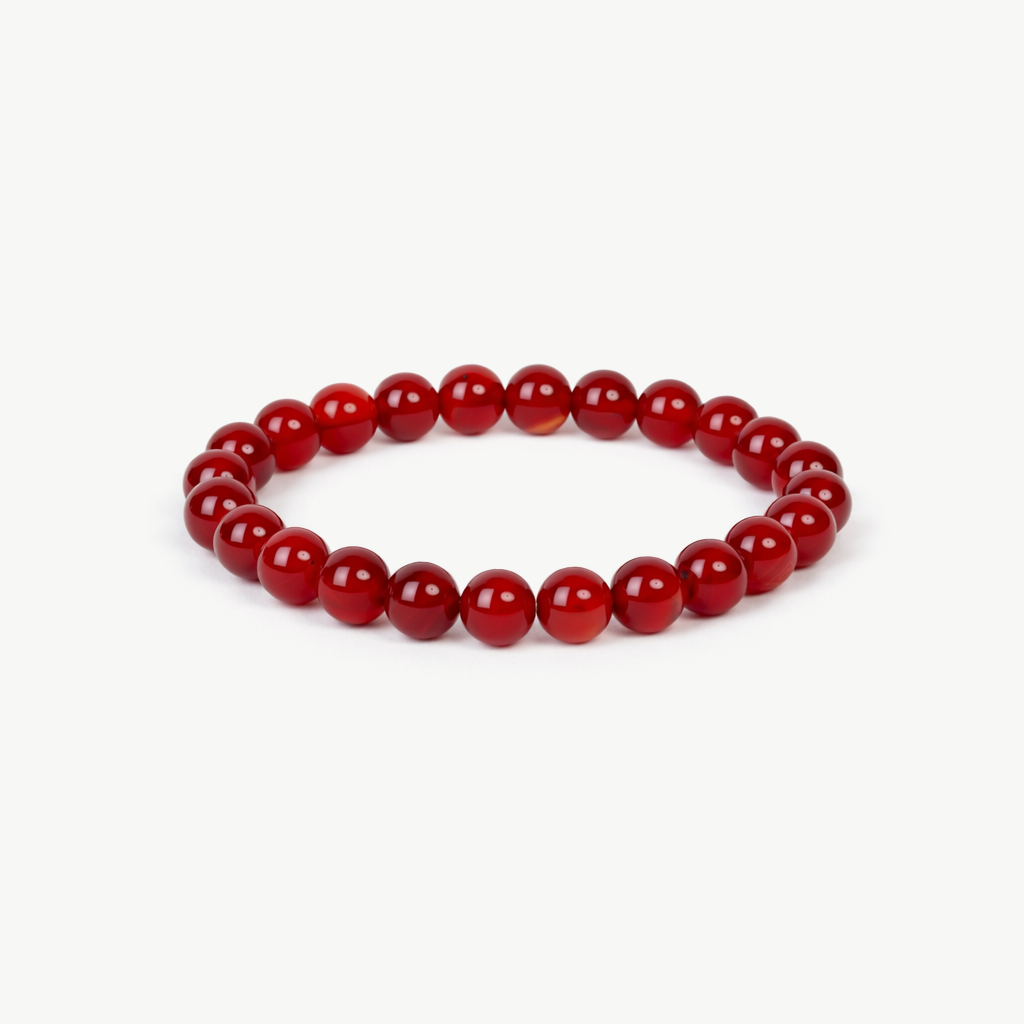 carnelian beaded bracelet with deep red polished round stones on a stretch cord, on a white background