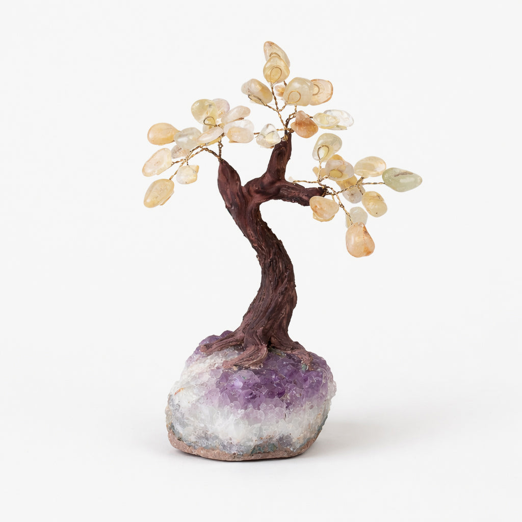 citrine gemstone tree with golden citrine leaves on a natural amethyst geode base
