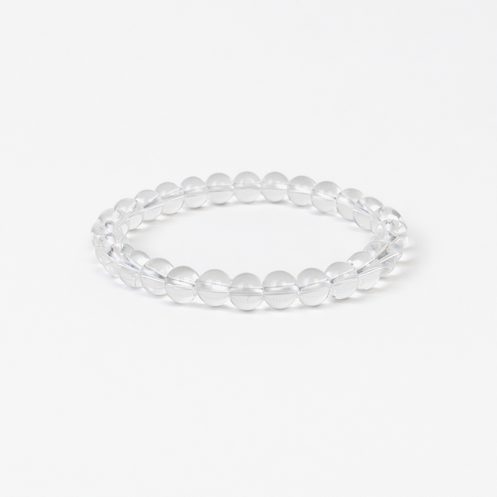 clear quartz beaded bracelet with polished round clear quartz stones on a stretch cord, on a white background