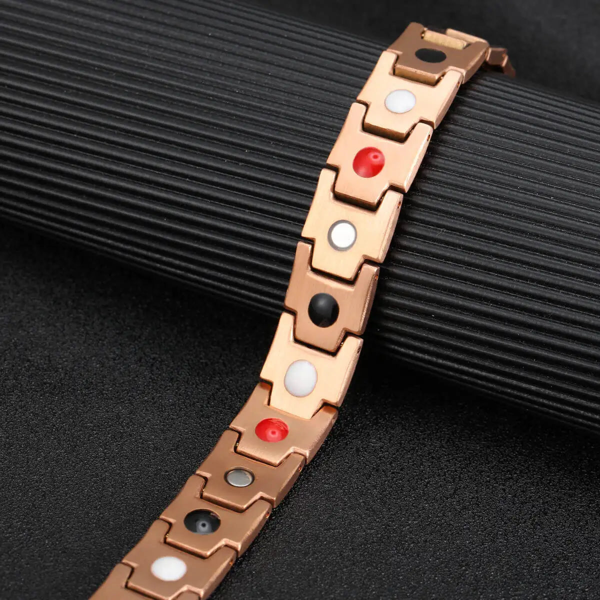 copper bracelet 1x shown at an angle on a dark ridged surface