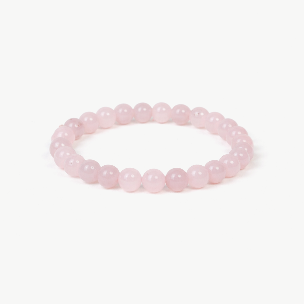 rose quartz beaded bracelet with pale pink polished round stones on a stretch cord, on a white background