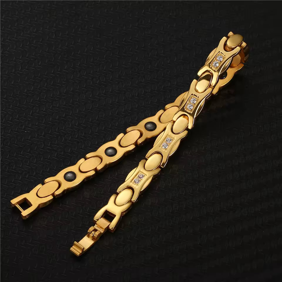 two crystal bracelet gold pieces displayed on a black carbon-fibre background
