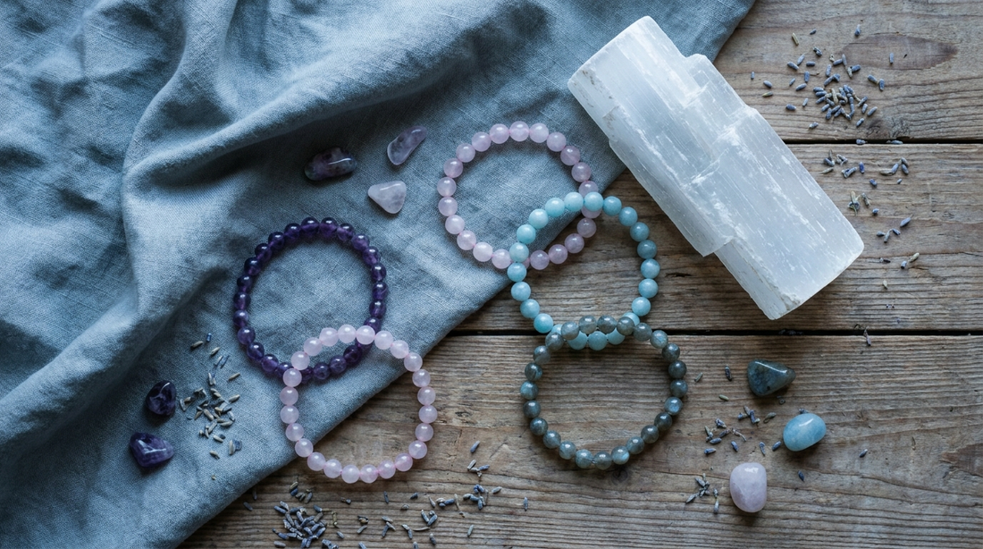 Crystal beaded bracelets with a soft cloth and a piece of selenite arranged for a cleansing ritual