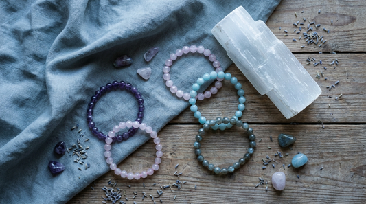 Crystal beaded bracelets with a soft cloth and a piece of selenite arranged for a cleansing ritual