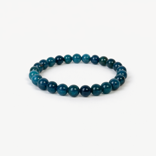 Apatite Clarity beaded bracelet with deep teal-blue polished round stones on a stretch cord