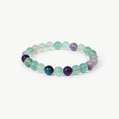 Fluorite Balance beaded bracelet with pale green and purple round fluorite stones on a white background