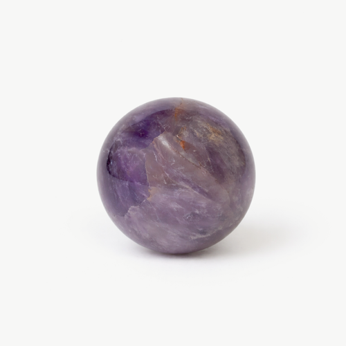 Polished amethyst sphere with purple and white banding on a white background