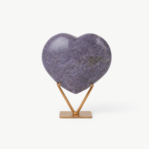 Polished amethyst heart on a gold metal display stand