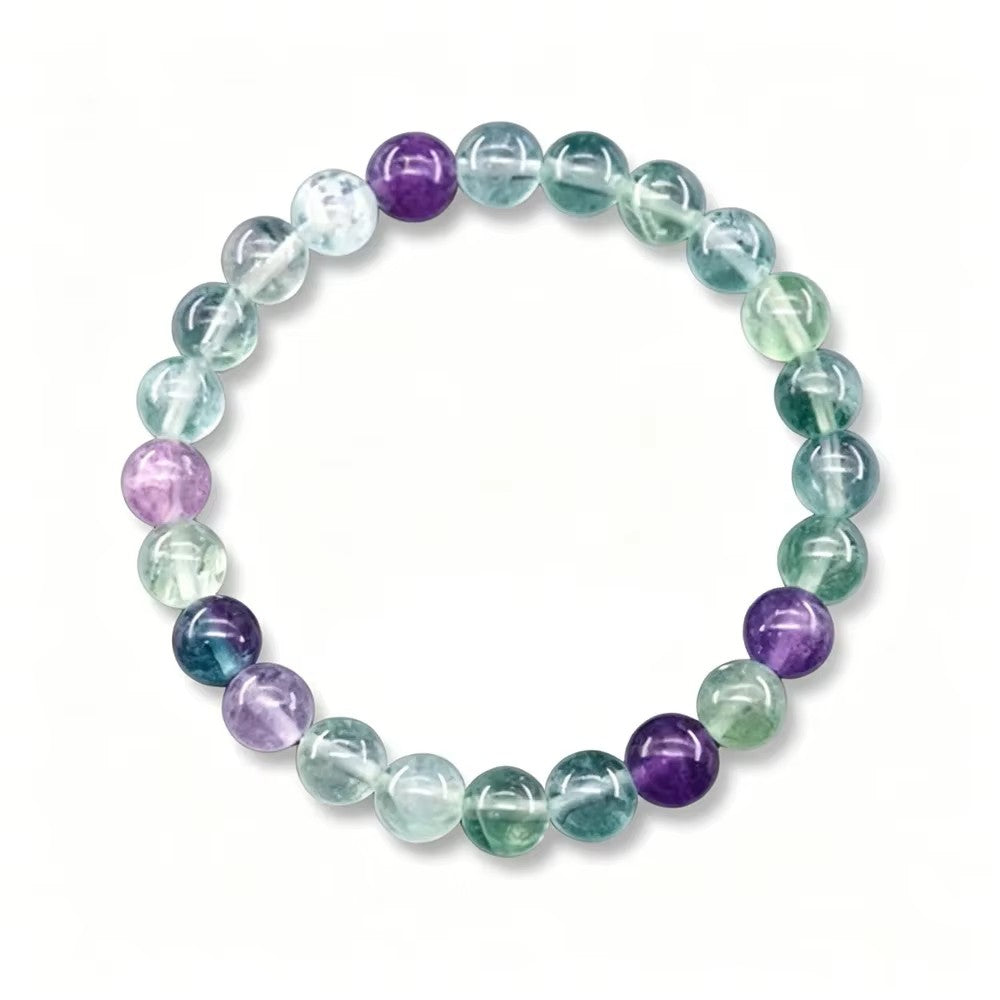 fluorite balance beaded bracelet with green, purple and clear fluorite stones on a white background
