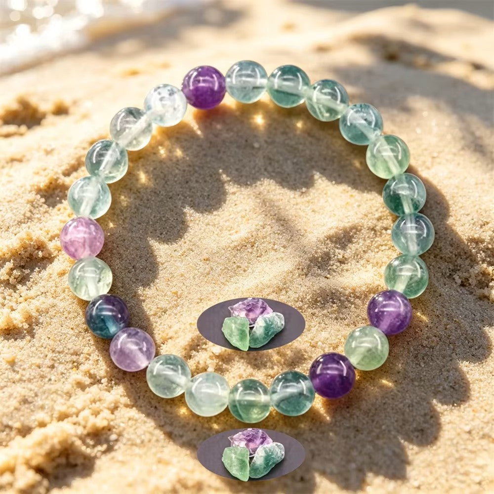 Fluorite Balance beaded bracelet resting on sunlit sand